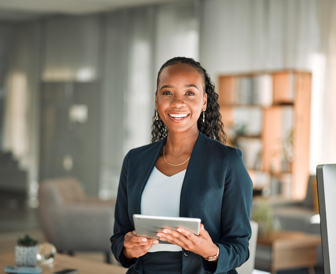 Woman in a blue blazer holding a tablet