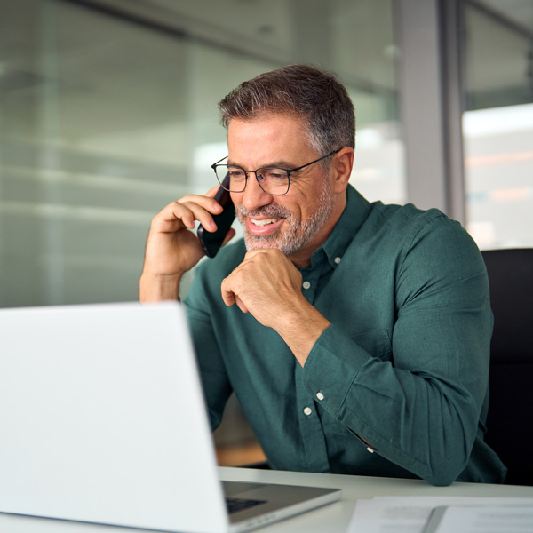 Man in a blue short busy with a phone call