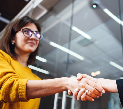 Broker shaking hands after making mortgage deal